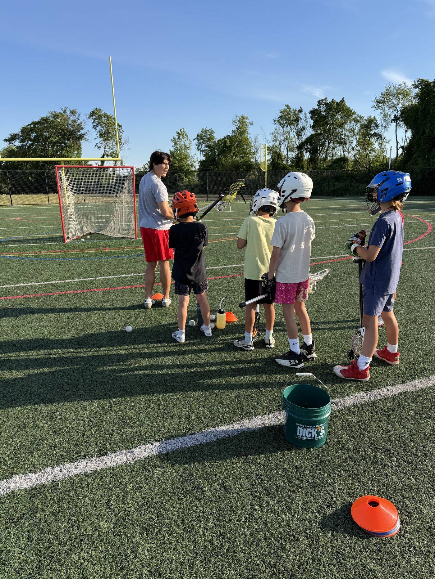 Youth players working through a cone drill at a clinic